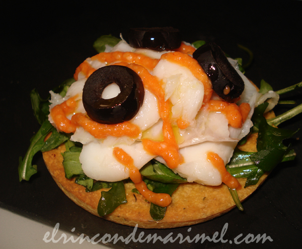 ensalada de bacalao y romesco sobre galleta de garbanzos